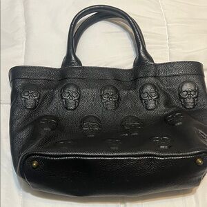 IO Pelle Italia leather tote bag featuring an embossed 3D skull design.